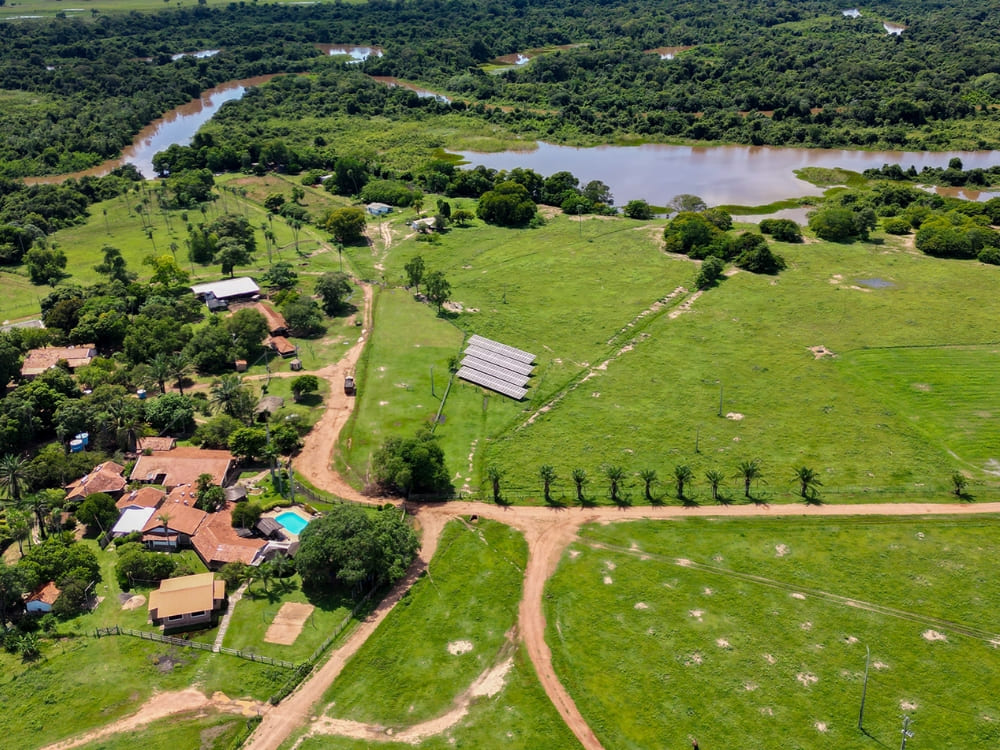 Aerial view of Aguapé lodge reveals a rich green area blending Cerrado vegetation with the Aquidauana River. Aerial view of Araras Lodge showing the swimming pool and eco-friendly infrastructure surrounded by the Pantanal ecosystem