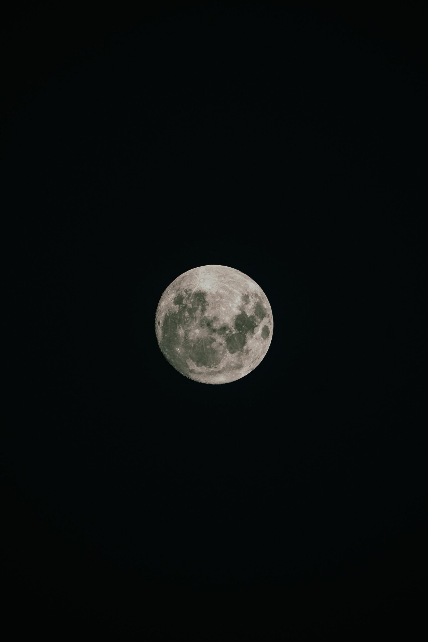 A full moon with clearly visible craters glowing against a completely dark night sky on the Tucano Amazon river cruise