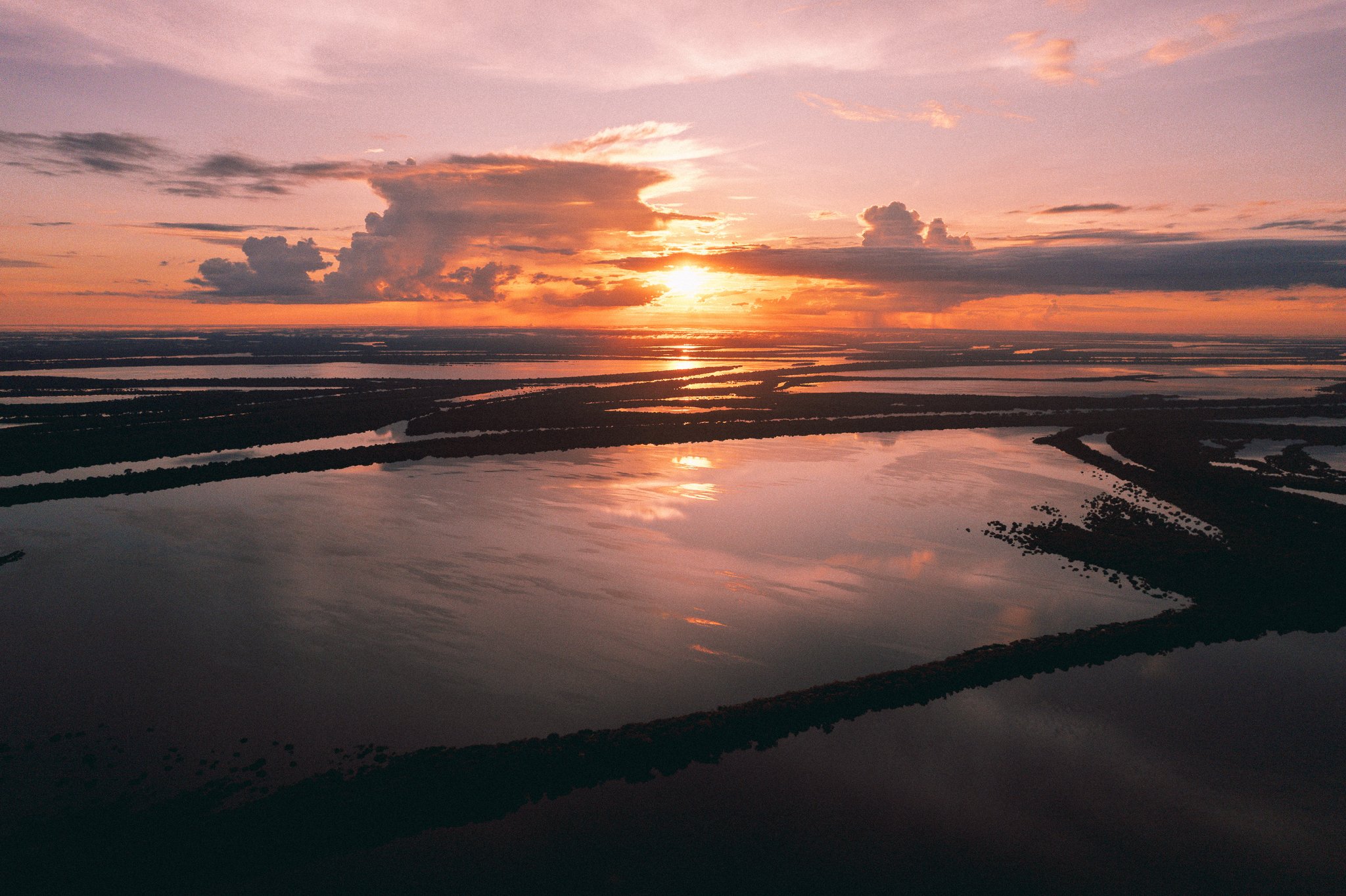 Aerial view of the flooded Anavilhanas archipelago glowing at sunset on a Brazil rainforest tour in the Amazon