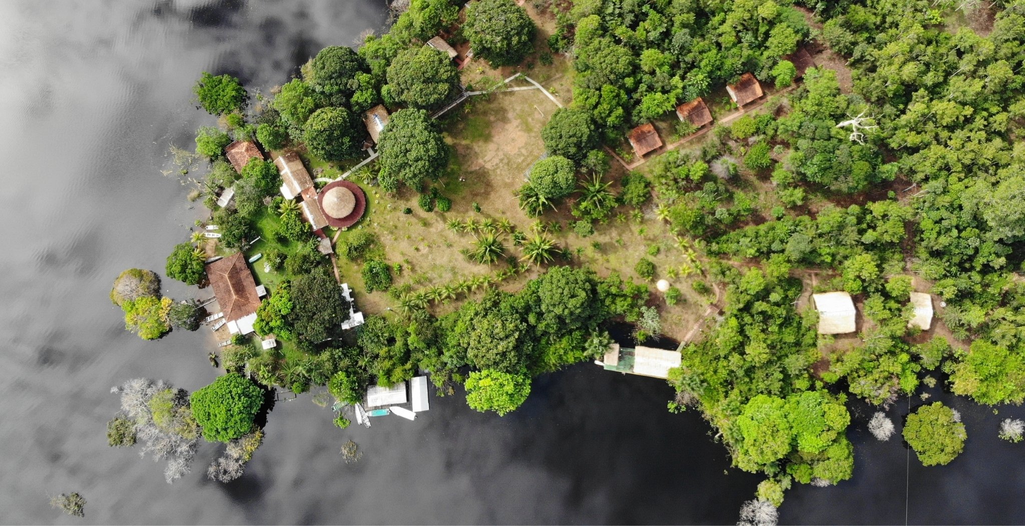 Aerial view of the Amazon Turtle Lodge on a forested river peninsula, the heart of an Amazon rainforest holiday in Brazil