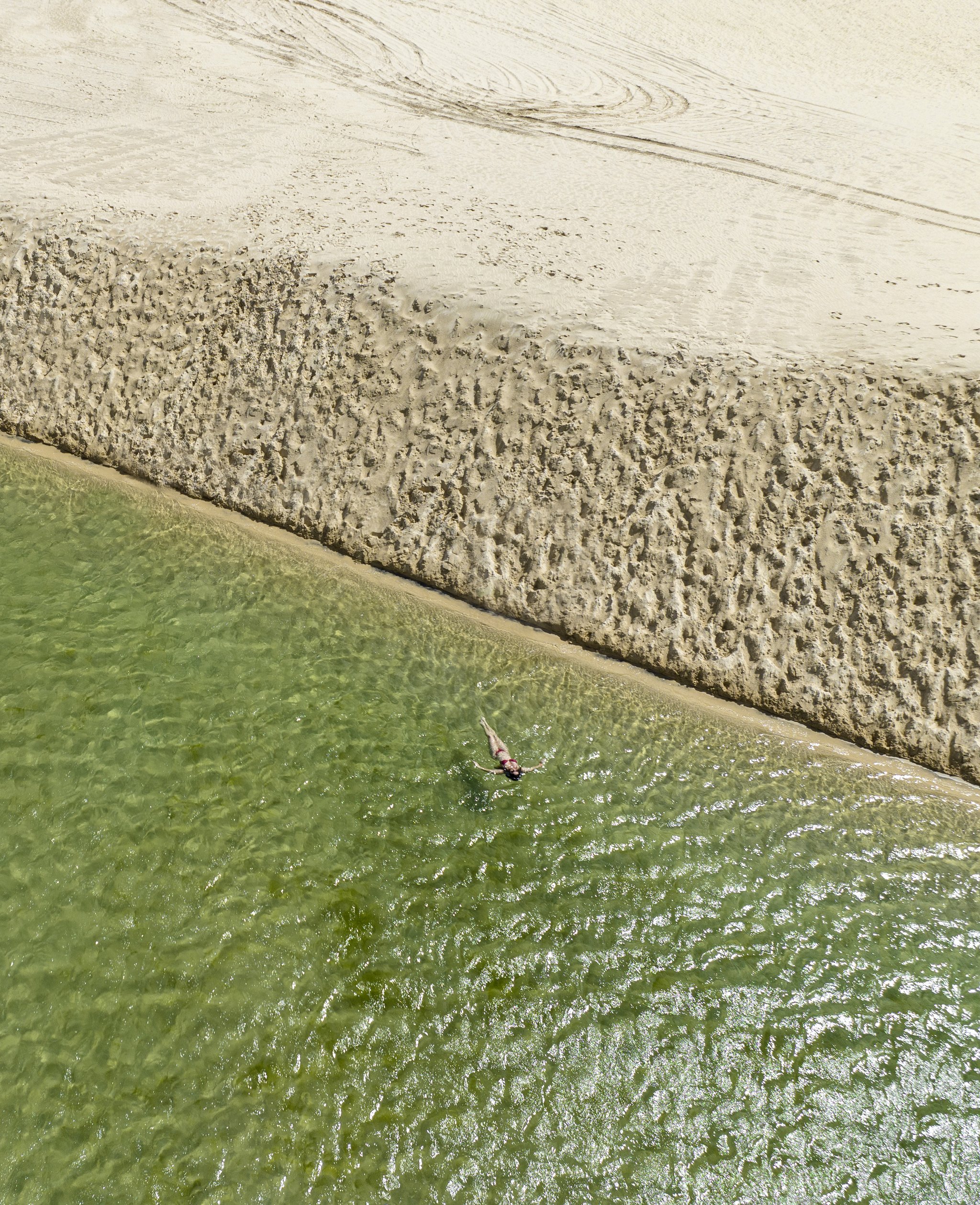 One swimmer, one sandbank, an impossible shade of green. Photo: Naeblys Photo 4