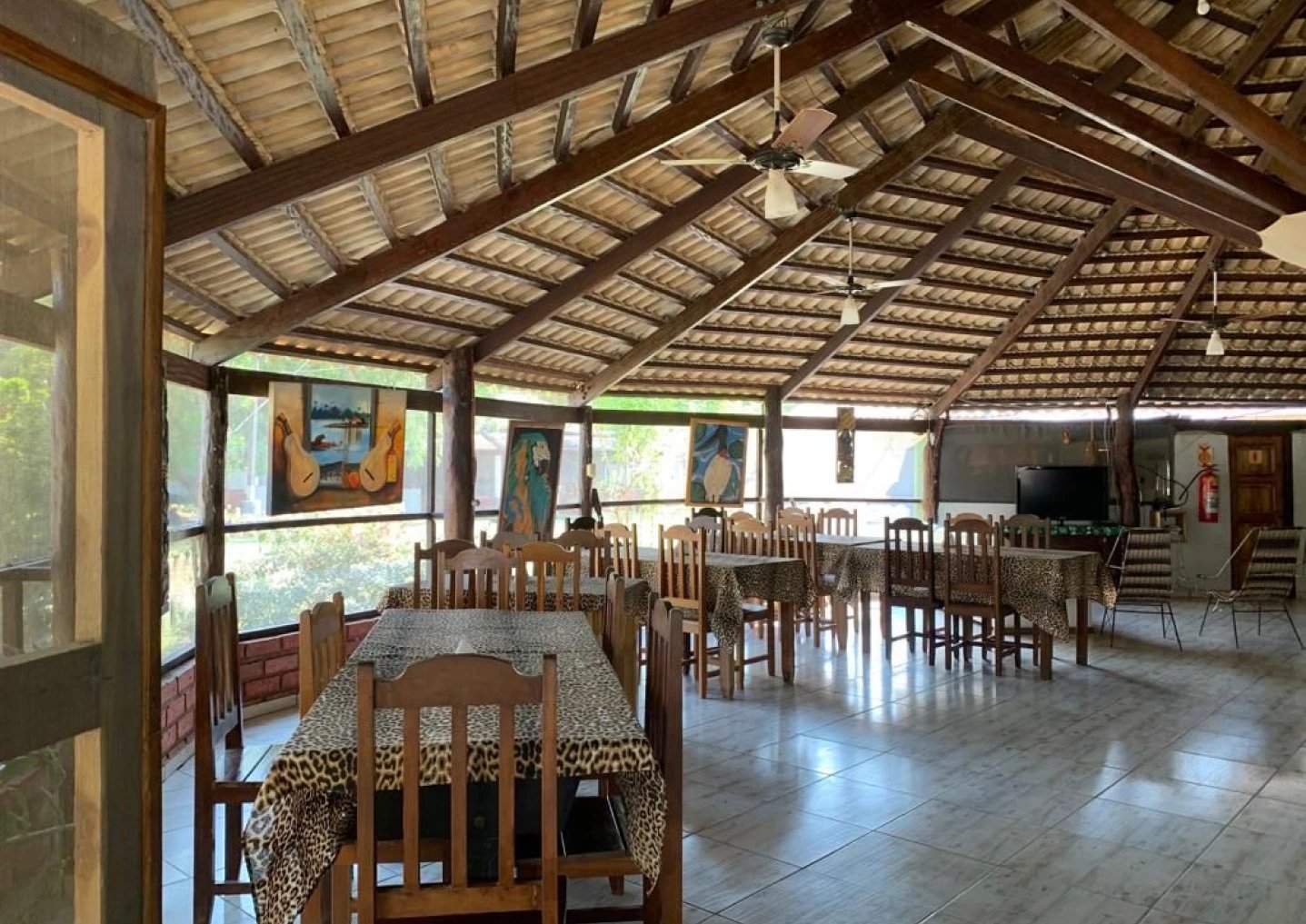 Thatched ceilings, warm timber, and wildlife art — meals here feel like part of the adventure. Photo 4