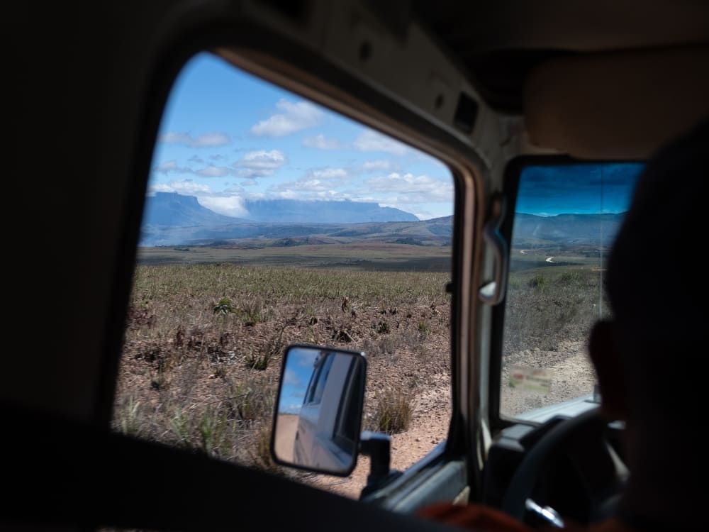 A 4x4 jeep transfer crossing the Gran Sabana with Mount Roraima in the distance