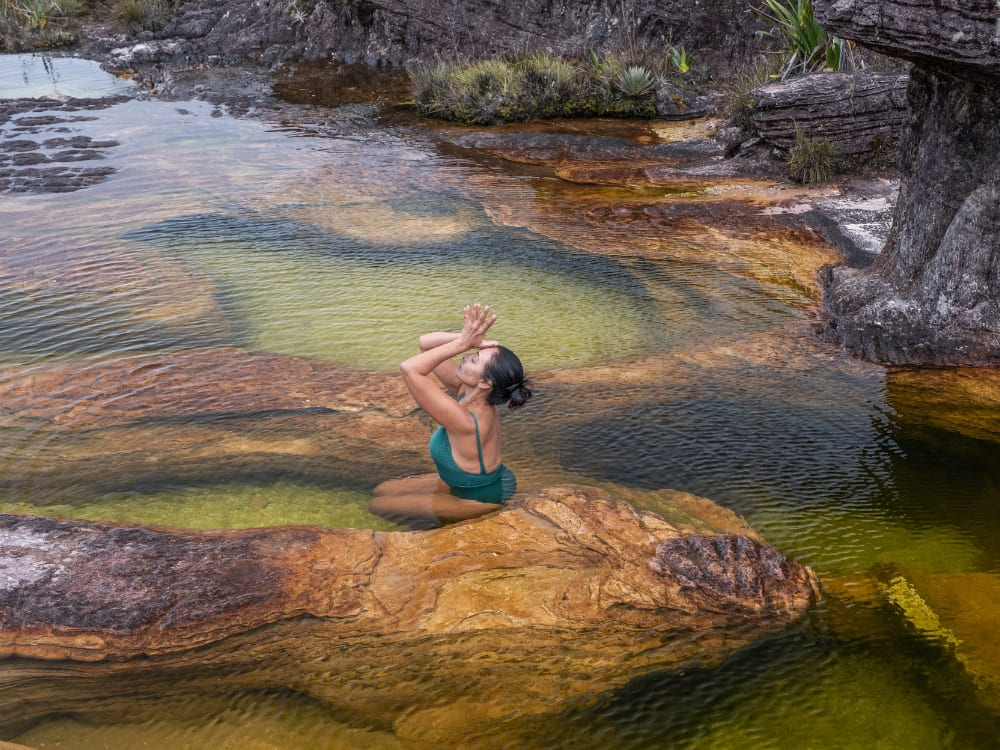 A trekker swimming in a natural jacuzzi pool on Mount Roraima