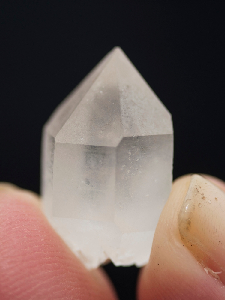 A hand holding a quartz crystal at the Crystal Valley of Mount Roraima