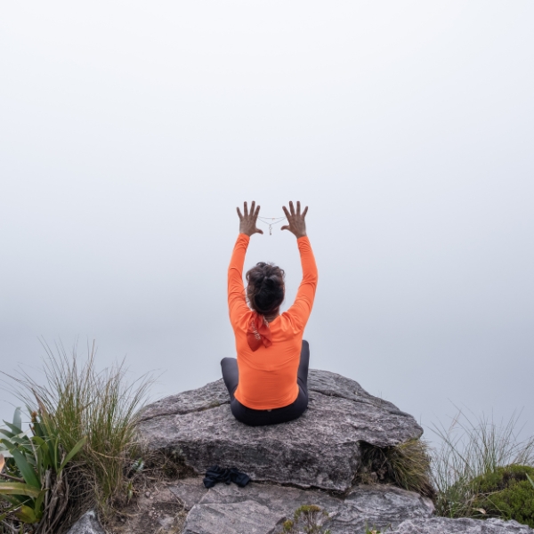 A traveler meditating in the fog on the summit plateau of Mount Roraima