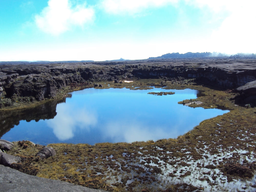 A dark natural pool on the summit plateau of Mount Roraima