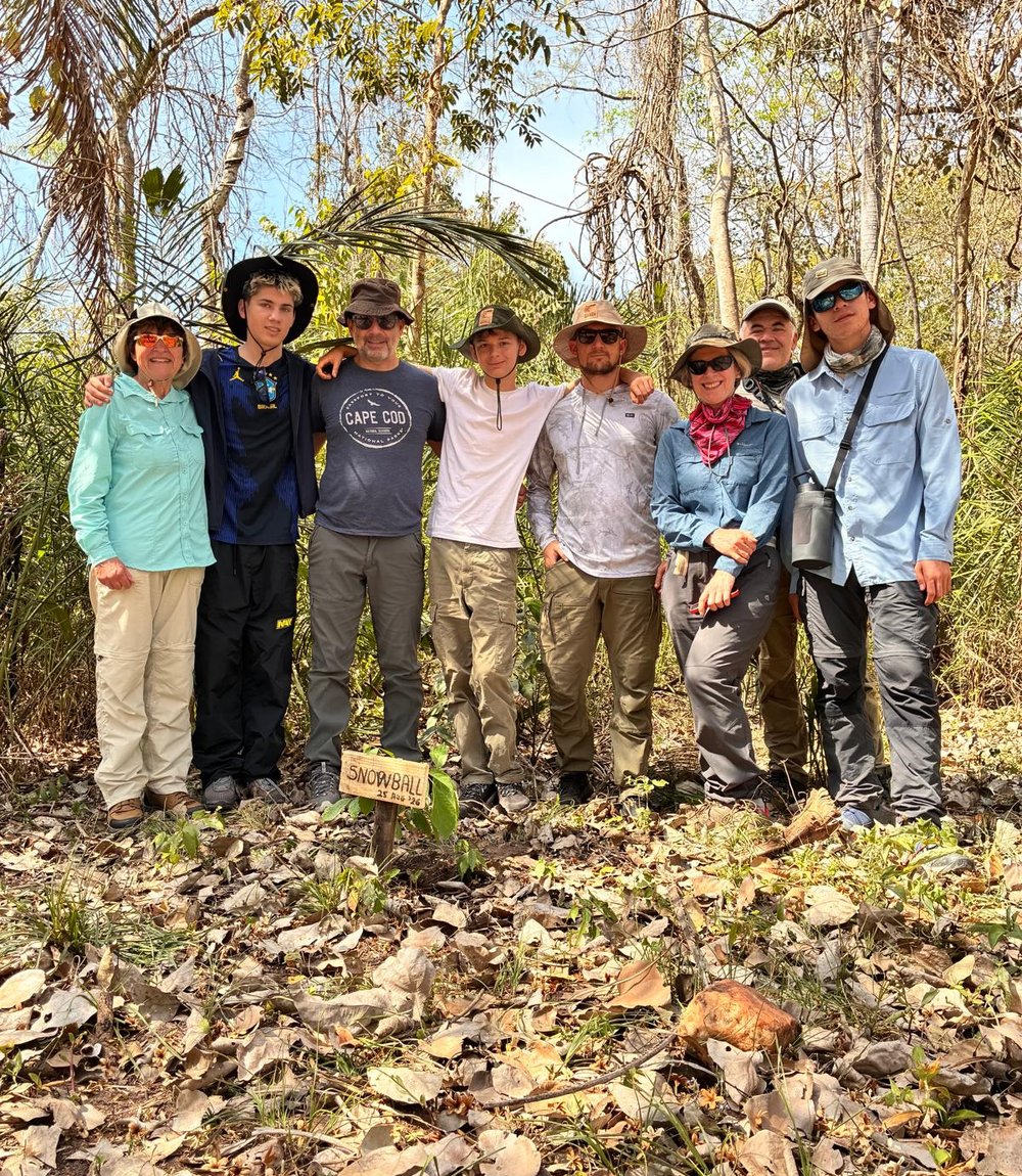 Andrea with her group of fellow travelers around the newly planted Snowball tree at Caiman